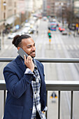 Smiling man talking via cell phone