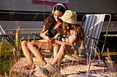 Girls relaxing on sun loungers