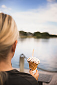 Woman's hand holding ice-cream cone