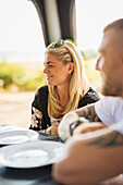 Smiling woman having meal at camping