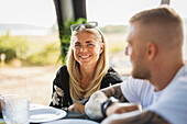 Smiling woman having meal at camping