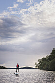 Woman paddle boarding on river