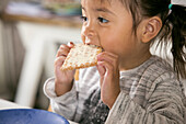 Girl eating bread