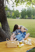 Mother and daughter having picnic