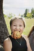 Smiling girl having cinnamon bun
