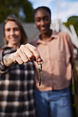 Smiling women holding house keys