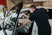 Salesman and female customer in car dealership