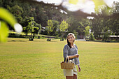 Woman with wicker basket looking away