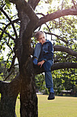 Girl sitting on tree