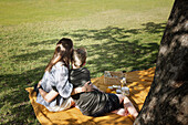 Mother with son sitting on picnic blanket