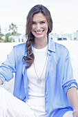 Young woman in white t-shirt, blue long blouse and white trousers