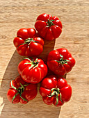 Beefsteak tomatoes on a wooden base