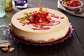 Baked cheesecake topped with strawberry sauce