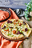 Leek quiche topped with beet and sweet potato chips