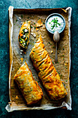 Spinach and vegetable filled pastry with feta and chive sauce