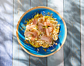 Tuna slices on broccoli and cauliflower and hazelnuts