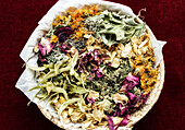 Various dried medicinal herbs in a basket