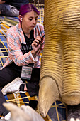 Workers assembling dinosaurs for Detroit Auto Show, USA