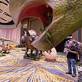 Workers assembling dinosaurs for Detroit Auto Show, USA