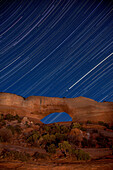 Star trails at night over Wilson Arch, Utah, USA