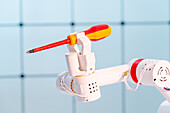 Robotic arm holding screwdriver