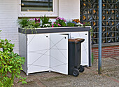 DIY box for the rubbish bins, with plants on top