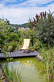 Relaxing chair by the garden pond