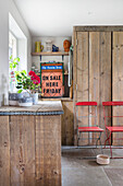 Utility room with cupboards made from reclaimed wooden boards