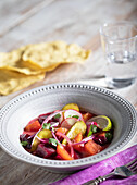 Red and yellow beet salad with radishes, red onion, pickle and lime