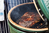 Barbequed smoked fish in a Green Egg