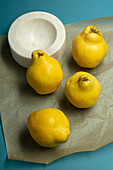 Marble bowl in front of fresh quinces