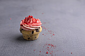 Vegan chocolate chip cupcake with strawberry frosting