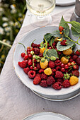 Mixed summer berries on a table in the garden