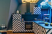 Kitchen with black and white zig-zag pattern in blue light