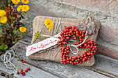 Jute packets decorated with tree bark and rosehip heart