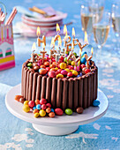 Birthday cake with chocolate sticks and colored chocolate candies