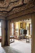 Decorative interior canopy of four postered bed 17th century flame stitch embroidery with oriental lacquered cabinet