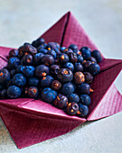 Juniper berries in origami paper bowls