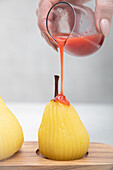 Poached pears with raspberry coulis
