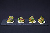 prawn fritter canapes on a slate serving tray