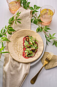 Ostrich carpaccio with sun-dried tomatoes and olive salad