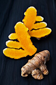 Fresh turmeric root, whole and halved