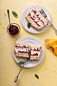 Vegan vanilla sponge cake filled with vegetable cream, cranberries, and almonds