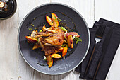 Roasted duck with vegetables and peach