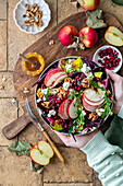 Apple and avocado salad with pomegranate seeds and walnuts