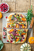 Pumpkin pinsa with figs, cranberries, rocket and red onions