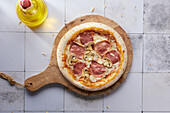Pizza with pepperoni, ham and mushrooms