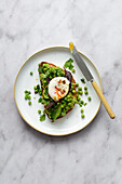 Toast with smashed avocado with poached egg and cilantro