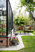 View from the greenhouse to the patio area with table and chairs