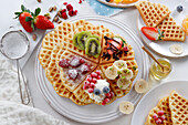 Heart-shaped waffles with assorted fruit toppings